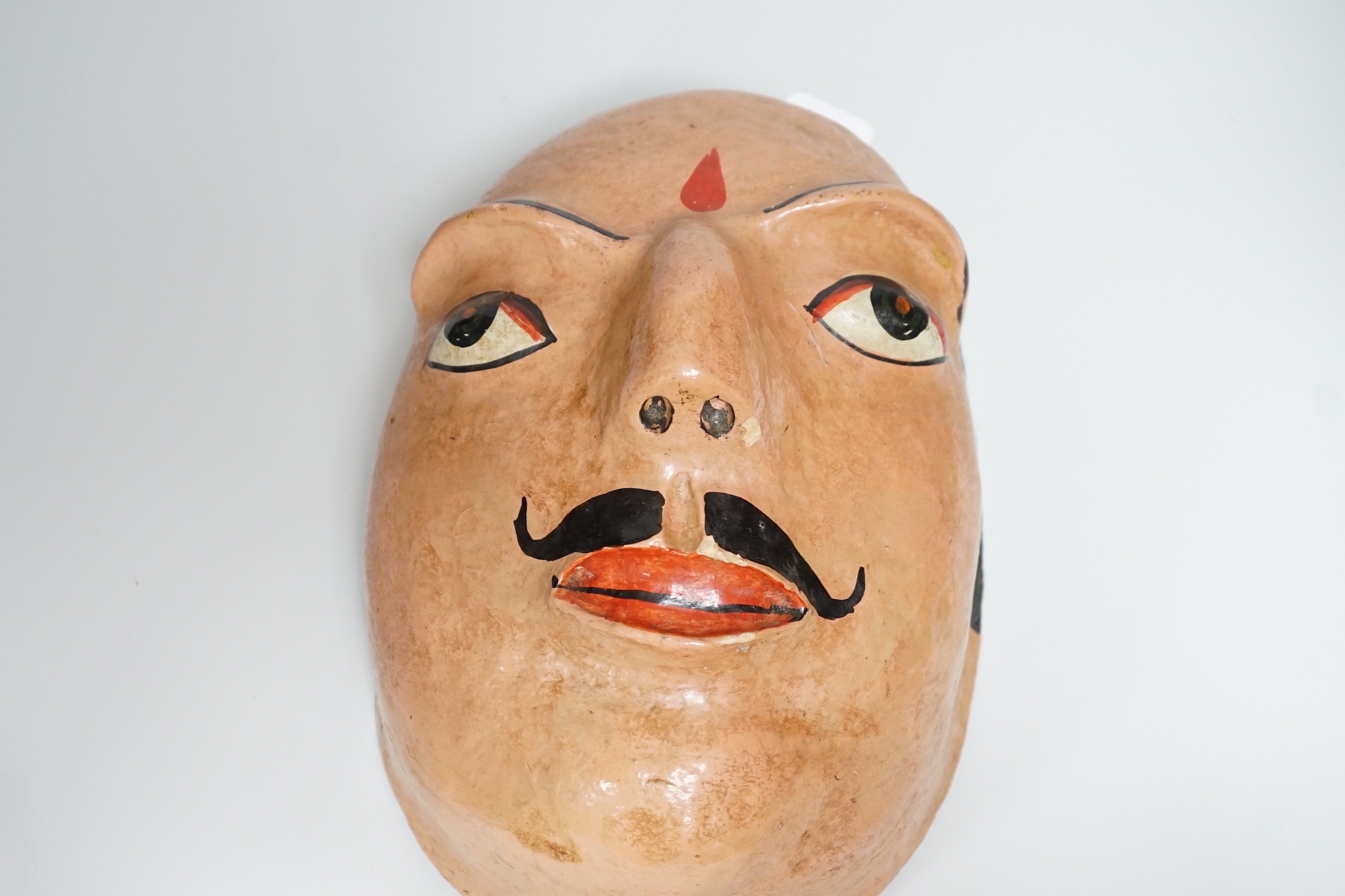 A papier mache wall mask of an Indian gentleman 32cm long